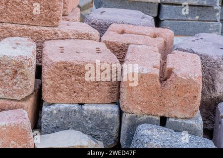 Closeup of used bricks stacked neatly in woodland construction site Stock Photo