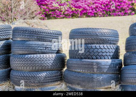 Stacks of old used tires in park with blurred background in Goseong, South Korea Stock Photo