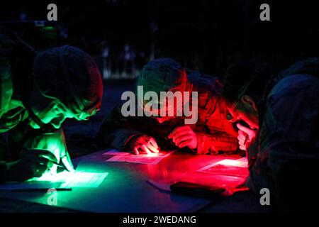 Fort Liberty, North Carolina, USA. 18th Jan, 2024. U.S. Army Paratroopers assigned to the 82nd Airborne Division, alongside medics assigned to the 44th Medical Brigade, plan their route at a night land navigation event during the Division's best medic competition on Fort Liberty, North Carolina, January. 18, 2024. The competition, hosted by the 82nd Abn. Div., tested Soldiers' medical knowledge and physical ability as they completed a 13-mile ruck, stress shoot, obstacle course, medical knowledge testing lanes, and a written test. The two highest scoring competitors from each unit are sc Stock Photo