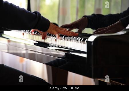 Close view of woman hand on piano keys while playing music Stock Photo