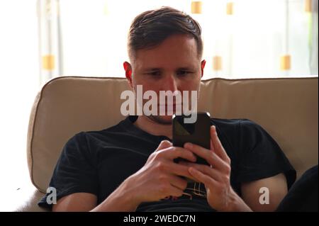 Closeup of handsome man using mobile phone Stock Photo