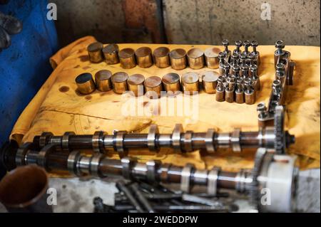 Steel cogs, details, equipment used by workers, repairmen. Engineers, mechanics working in garage, workshop, repairing, fixing cars. Concept of manual labor. Stock Photo