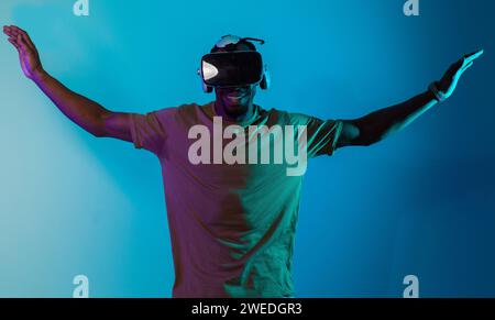 African American man dons VR glasses, engrossed in a virtual reality ...