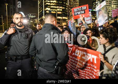 Tel Aviv, Israel. 24th Jan, 2024. Israeli police officers stand guard around women protesters blocking the Ayalon highway during the demonstration. Israeli women block the Ayalon highway demanding for an immediate hostages deal and ceasefire. 136 Israeli hostages are still held in Hamas captivity in Gaza in life threatening conditions after taken hostage during the 7th October attack. Credit: SOPA Images Limited/Alamy Live News Stock Photo