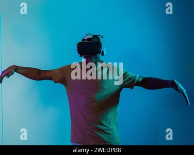 African American man dons VR glasses, engrossed in a virtual reality ...