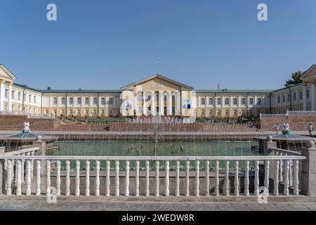 Khujand, Sughd, Tajikistan - 08 14 2019 : Landscape view of soviet era Arbob Palace with fountains in foreground Stock Photo