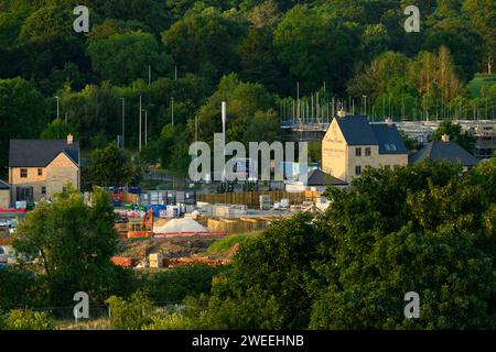 Building constructing houses in scenic rural valley (newly built, loss of green field land & fields) - Burley-in-Wharfedale, West Yorkshire England UK Stock Photo