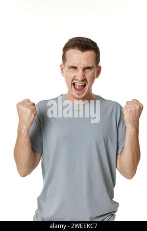 portrait of young man showing victory gesture on white background Stock Photo