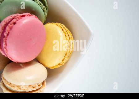 small macaroons in a white plate on a white background Stock Photo