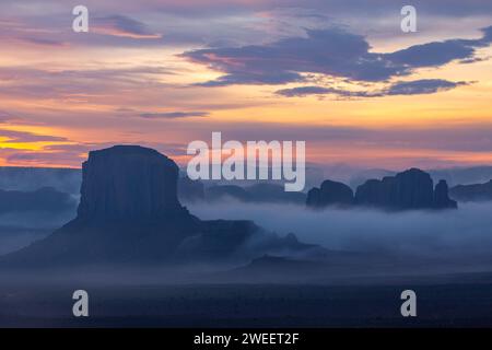 Foggy sunrise at Elephant Butte & Camel Rock in the Monument Valley Navajo Tribal Park in Arizona. Stock Photo