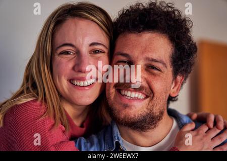 Headshot of a Cheerful caucasian couple at home looking at camera smiling. Stock Photo