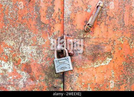 Rusty metal padlock on an old grunge metal gate Stock Photo