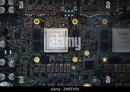 Honolulu, Hi - January 12, 2024: Tesla Artificial Intelligence full self driving autopilot brain semiconductor processor closeup on motherboard Stock Photo