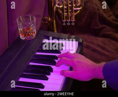 Piano Playing At The Jazz Club With Glass Of Whiskey Stock Photo