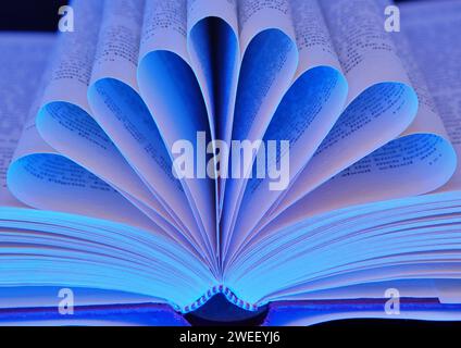 Pages Of Book Folded With Blue Light Stock Photo
