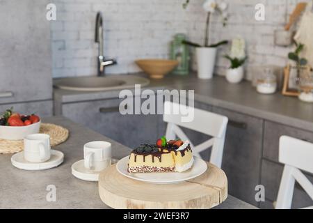 Contemporary kitchen scene featuring dessert and coffee for two. Artificial food. Stock Photo