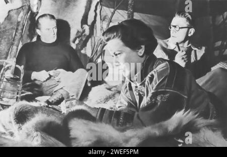 Jack Warner, John McCallum, and Nadia Gray star in 'Valley of Eagles' (1951), a British adventure film. Directed by Terence Young, the movie is set in Sweden and follows the story of Dr. Nils Ahlen, played by McCallum, a Swedish scientist who embarks on a journey to recover a stolen invention, a powerful new source of energy. Warner plays Inspector Peterson, a police officer involved in the case, and Gray portrays Kara, a native Lapp woman who becomes crucial to Ahlen's quest. Stock Photo