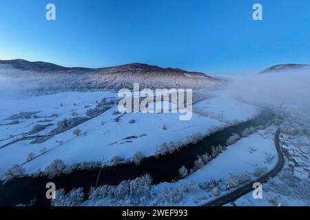 Beautiful Krka river near Dolenjske toplice in early morning hours on a cold winter day, with Kocevski rog behind, Dolenjske toplice, Slovenia Stock Photo