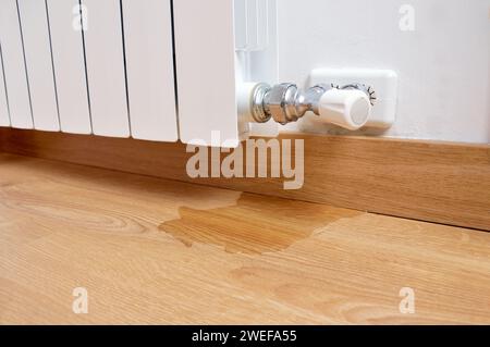 water leak through the heating radiator tube nut Stock Photo - Alamy