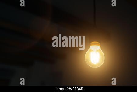 Lit Incandescent light bulb with a medium-sized E27. Stock Photo