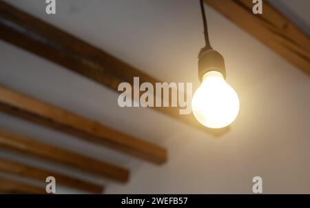 Lit Incandescent light bulb with a medium-sized E27. Stock Photo