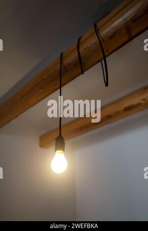 Lit Incandescent light bulb with a medium-sized E27. Stock Photo