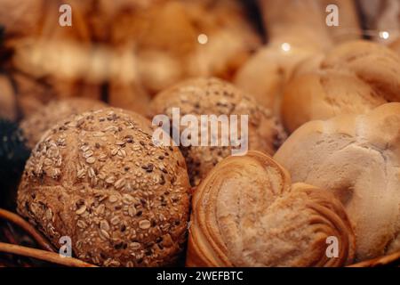 Fresh baked multigrain bread in a wicker basket in a baked goods store Stock Photo