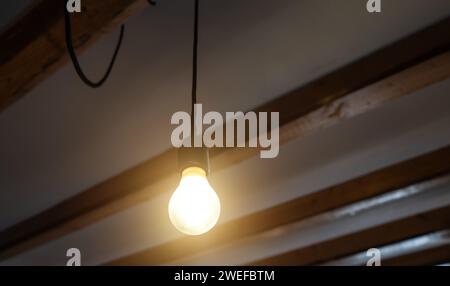 Lit Incandescent light bulb with a medium-sized E27. Stock Photo