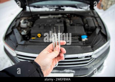 Modern glow plug with a ceramic rod for a diesel engine on a black ...