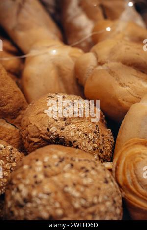 Fresh baked multigrain bread in a wicker basket in a baked goods store Stock Photo