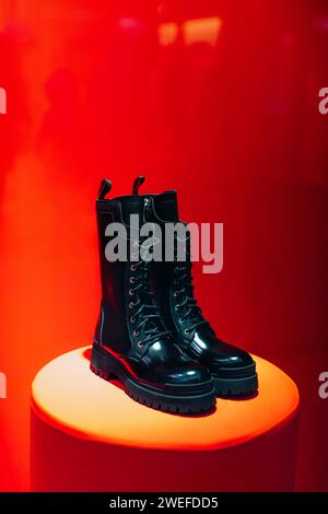 Black women's patent leather lace-up shoes on a boutique stand on a red background Stock Photo