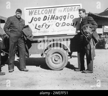New York Yankees' star Joe DiMaggio (right) and 'Lefty' O'Doul, Manager of the San Francisco Seals, arrive at Kimpo AFB, and are met by a poster mounted on a jeep saying, 'Welcome to Korea Joe DiMaggio and 'Lefty' O'Doul, Kimpo AFB, Korea, 11/10/1950. Photo by US Signal Corps/US Army Stock Photo