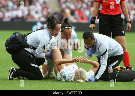 Beth Mead lies injured on pitch attended by physio and doctor Ritan Mehta during UEFA Women's Euro Final 2022 at Wembley Stadium, London 31 July 2022 Stock Photo