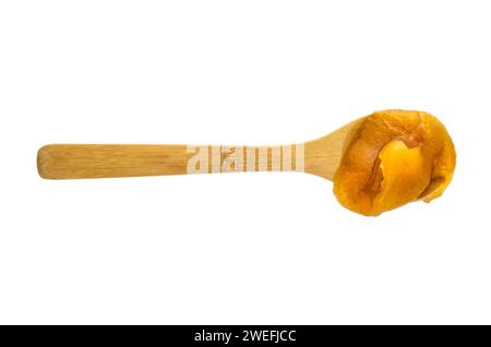Fresh honey in a wooden spoon isolated on white background, flat lay, table top view Stock Photo