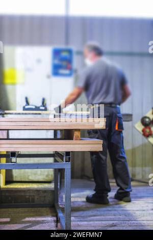 worker operating machine in wood processing facility Stock Photo