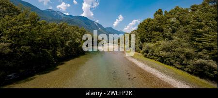 Panoramic view of the Ticino river in Switzerland. The water is crystal clear, there is a beach and many trees along the river. Nobody inside Stock Photo