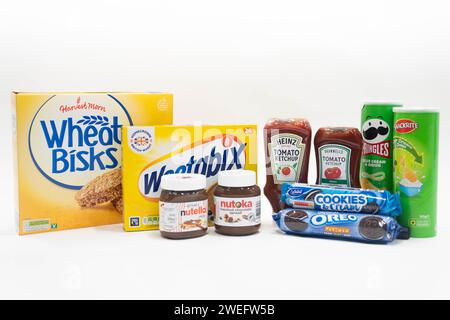 A line-up of well-known consumer brands alongside products sold by Aldi of (left to right) Wheat Bisks and Weetabix cereal, Nutella and Nutoka chocolate spread, Heinz tomato ketchup and Bramwells tomato ketchup, sour cream and onion Pringles and Snackrite crisps, and original Oreos and Belmont Cookies and Cream biscuits. Aldi's high-profile legal spats with its brand rivals are stacking up as the discounter's thriving UK customer base continues to expand. The latest trademark infringement claim against Aldi, by Thatchers Cider, has been dismissed in the High Court, landing a blow for brands wh Stock Photo