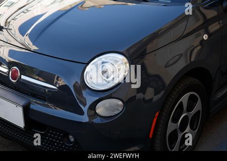 Headlights and front wheel of a modern car close-up, elegant auto design. Stock Photo