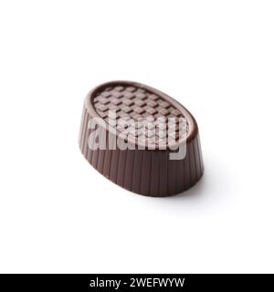 Chocolate candy on white isolated, close-up. Chocolate praline, sweets. Stock Photo