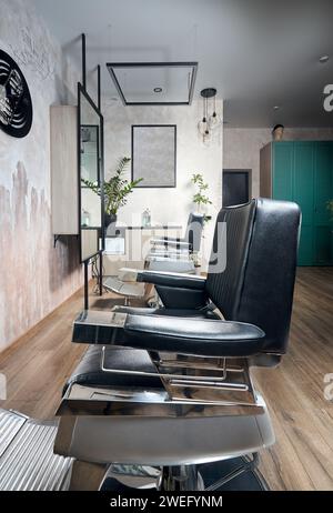 Barber shop or barbershop vintage interior design hair man salon empty with chairs. Vertical shot. Stock Photo