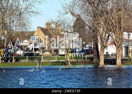 A flooded Manor Park caused by winter storms on a sunny winter's day Surrey England UK Stock Photo