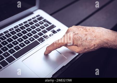 old persons finger on computer keyboard Stock Photo