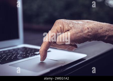 old persons finger on computer keyboard Stock Photo