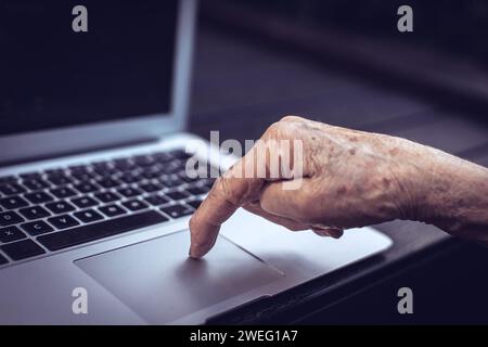 old persons finger on laptop keyboard Stock Photo