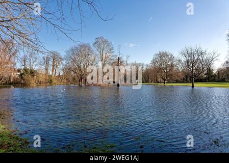 A flooded Manor Park caused by winter storms in Shepperton on a sunny winters day Surrey England UK Stock Photo