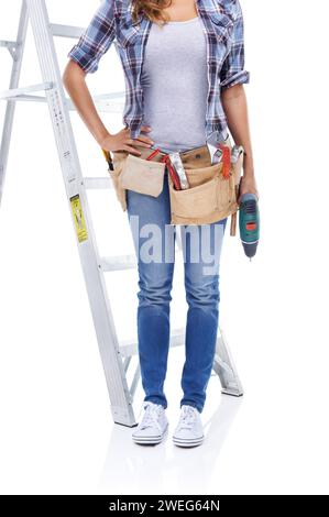 Building, construction or DIY and woman with ladder in studio isolated on white background for project. Renovation, maintenance and repair with Stock Photo