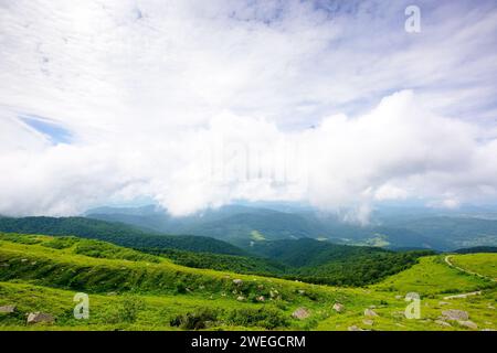 wonderful alpine landscape of ukraine in summer. clouds above the rolling hills and green meadows of carpathian mountains Stock Photo