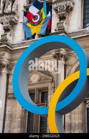 Paris, France - February 21, 2023 : Paris 2024 summer Olympic Games. Olympic rings in front of Hotel de Ville city hall; Ukrainian flags on building. Stock Photo