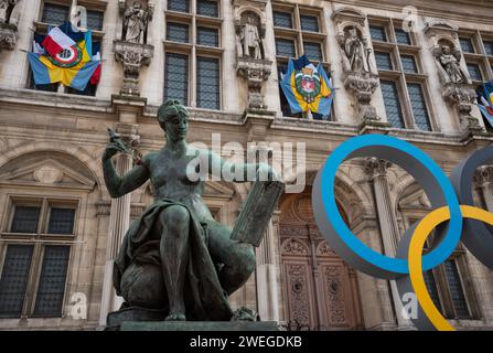 Paris, France - February 21, 2023 : Paris 2024 summer Olympic Games. Rings near Hotel de Ville; Ukrainian flags to support Ukraine; Woman statue Stock Photo