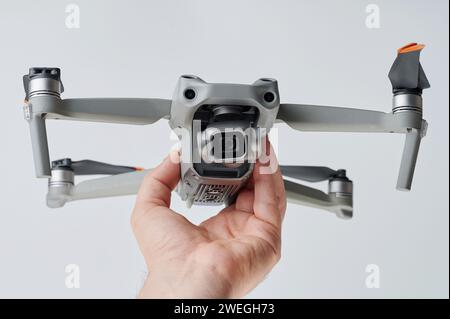 Gray drone with camera in hand isolated on white studio background Stock Photo